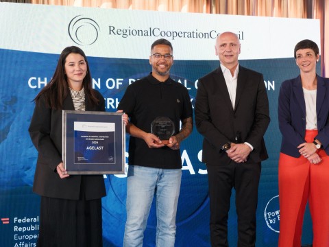 RCC Secretary General Amer Kapetanovic and Austrian Ambassador to Albania, Monika Zach with winners of Champion of Regional Cooperation Dr Erhard Busek Award for year 2024 - Agelast podcast - at the ceremony held in Tirana on 15 June 2025 (Photo: RCC/Armand Habazaj)